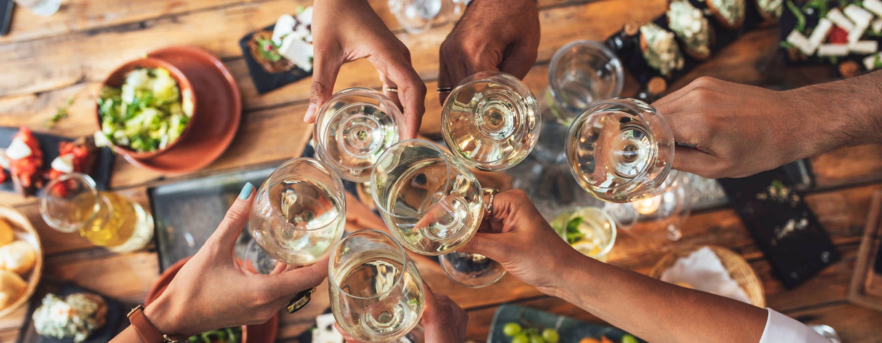 residents toast glasses around large dinner table